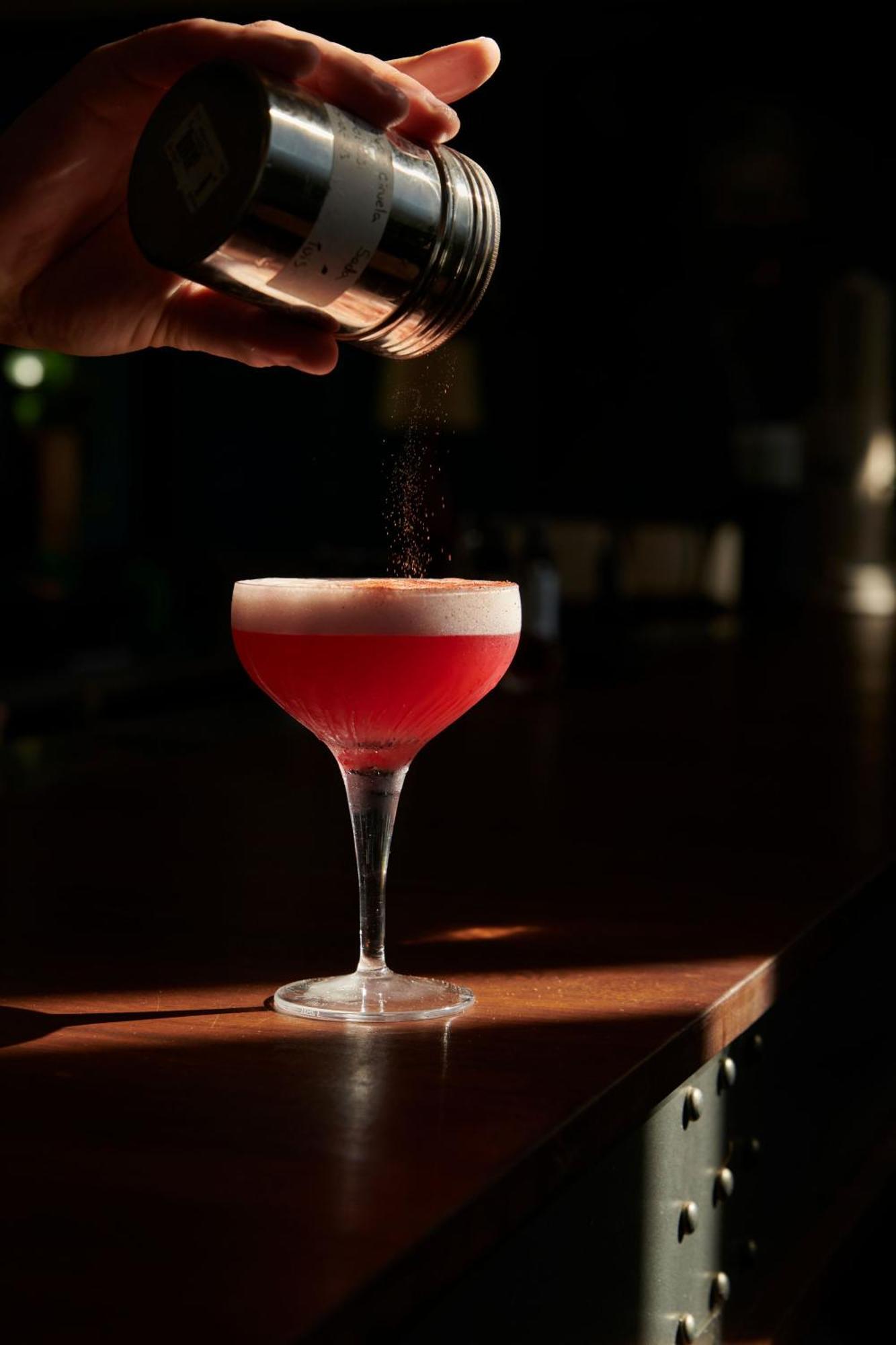 The Click Clack Hotel Medellín Kültér fotó A Clover Club cocktail being garnished with ground nutmeg